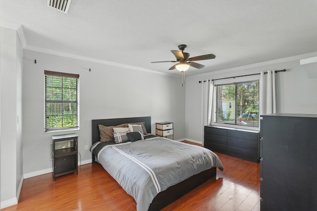 131 Boulder Rock Dr, Palm Coast, FL 32137 - bedroom featuring multiple windows, wood finished floors, crown molding, and ceiling fan