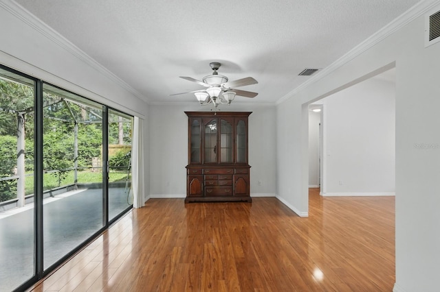 131 Boulder Rock Dr, Palm Coast, FL 32137 - spare room with wood finished floors, a ceiling fan, and ornamental molding