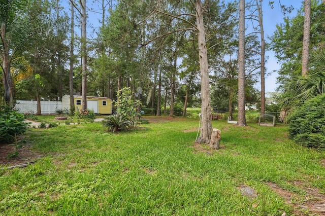 131 Boulder Rock Dr, Palm Coast, FL 32137 - view of yard featuring a storage unit and view of wooded area