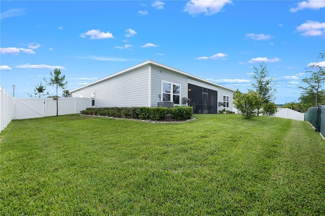 2137 Raglan Cir, Ormond Beach, FL 32174 - rear view of property with a fenced backyard, a gate, and a sunroom