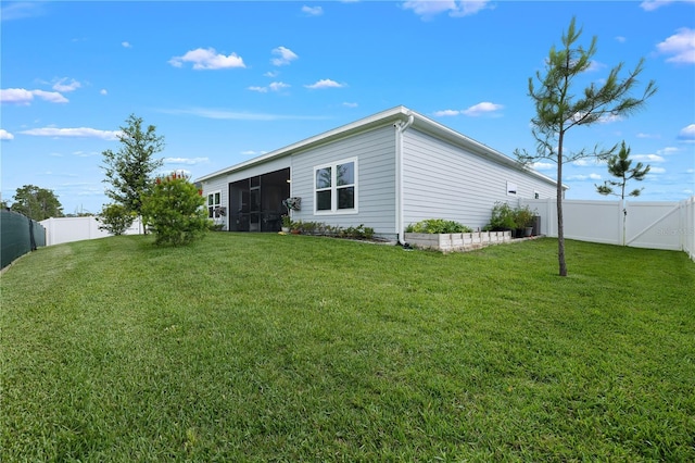 2137 Raglan Cir, Ormond Beach, FL 32174 - back of property featuring a fenced backyard, a sunroom, and a gate