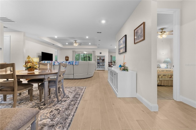 2137 Raglan Cir, Ormond Beach, FL 32174 - dining area featuring a ceiling fan, a tray ceiling, light wood-style floors, and recessed lighting