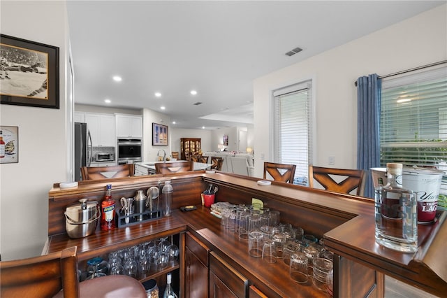 2137 Raglan Cir, Ormond Beach, FL 32174 - indoor dry bar featuring appliances with stainless steel finishes, recessed lighting, and plenty of natural light