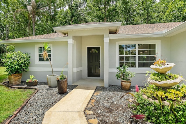 7 Zeolite Pl, Palm Coast, FL 32164 - doorway to property featuring a shingled roof and stucco siding