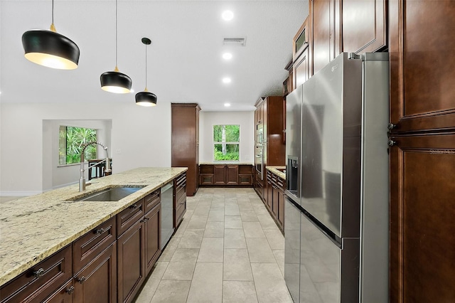 7 Zeolite Pl, Palm Coast, FL 32164 - kitchen with appliances with stainless steel finishes, decorative light fixtures, light stone counters, light tile patterned flooring, and recessed lighting