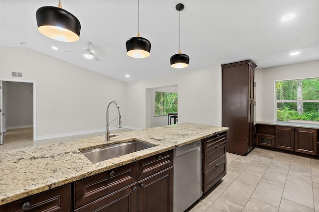 7 Zeolite Pl, Palm Coast, FL 32164 - kitchen with stainless steel dishwasher, pendant lighting, dark brown cabinets, light stone countertops, and lofted ceiling