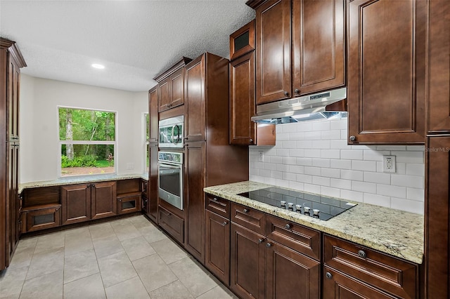 7 Zeolite Pl, Palm Coast, FL 32164 - kitchen with appliances with stainless steel finishes, under cabinet range hood, backsplash, light stone countertops, and recessed lighting