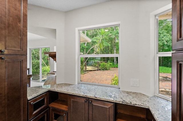 7 Zeolite Pl, Palm Coast, FL 32164 - kitchen with dark brown cabinetry and light stone counters