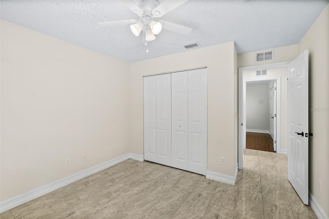 7 Zeolite Pl, Palm Coast, FL 32164 - unfurnished bedroom with a closet, a textured ceiling, and ceiling fan