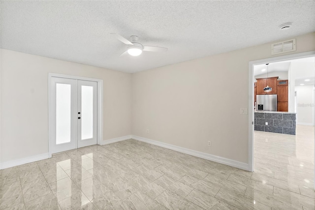7 Zeolite Pl, Palm Coast, FL 32164 - spare room featuring ceiling fan, a smoke detector, a textured ceiling, french doors, and light marble finish flooring