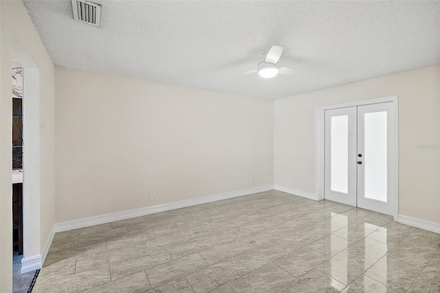 7 Zeolite Pl, Palm Coast, FL 32164 - empty room with a textured ceiling, a ceiling fan, french doors, and light marble finish flooring
