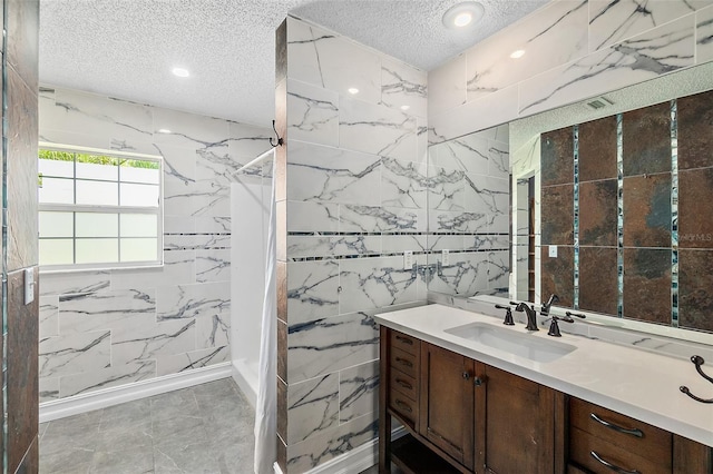 7 Zeolite Pl, Palm Coast, FL 32164 - bathroom featuring a textured ceiling, a marble finish shower, vanity, tile walls, and recessed lighting