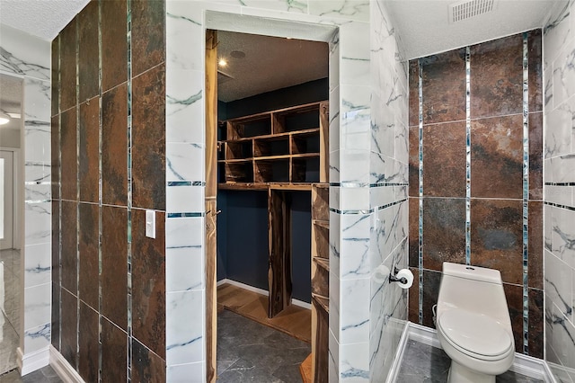 7 Zeolite Pl, Palm Coast, FL 32164 - bathroom with toilet and a textured ceiling