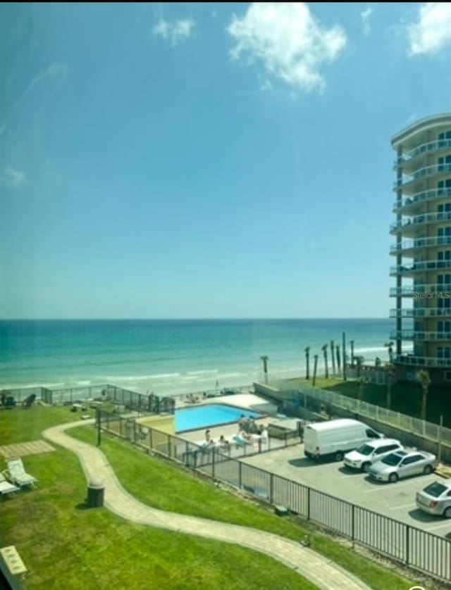 1909 S Atlantic Ave Unit 405/406, Daytona Beach Shores, FL 32118 - view of community featuring a water view and uncovered parking
