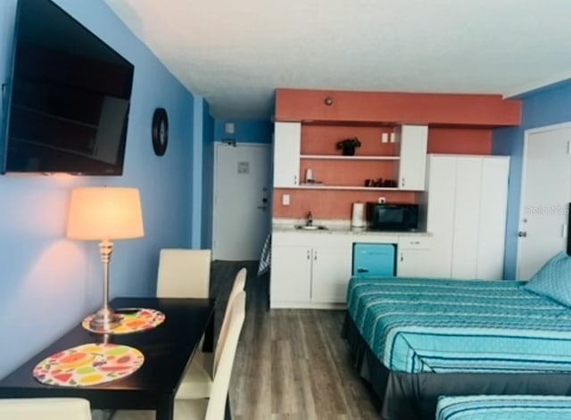 1909 S Atlantic Ave Unit 405/406, Daytona Beach Shores, FL 32118 - bedroom with wood finished floors