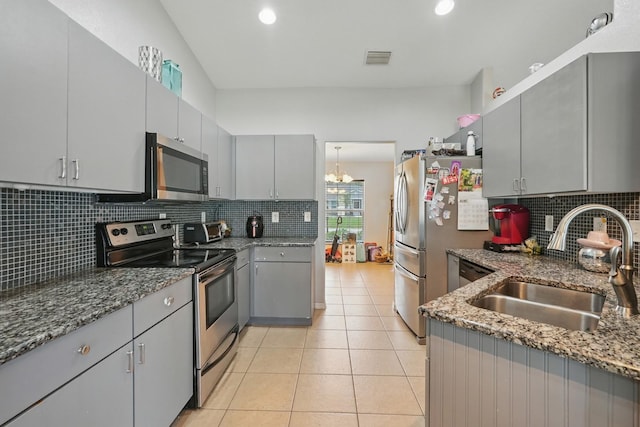 8 Severn Ct, Palm Coast, FL 32164 - kitchen with gray cabinetry, appliances with stainless steel finishes, backsplash, dark stone counters, and recessed lighting