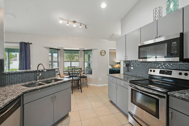 8 Severn Ct, Palm Coast, FL 32164 - kitchen with appliances with stainless steel finishes, gray cabinetry, tasteful backsplash, and healthy amount of natural light