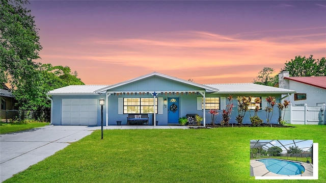 29 Firtree Ln, Palm Coast, FL 32137 - ranch-style house featuring an attached garage, a metal roof, covered porch, driveway, and stucco siding