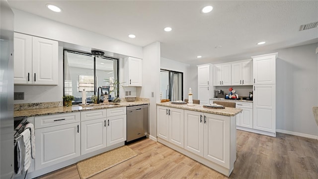 29 Firtree Ln, Palm Coast, FL 32137 - kitchen with stainless steel dishwasher, range, a peninsula, light wood-style floors, and recessed lighting