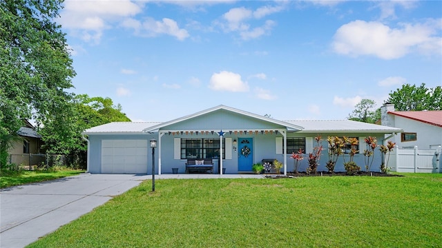 29 Firtree Ln, Palm Coast, FL 32137 - ranch-style house with a garage, concrete driveway, covered porch, and a metal roof