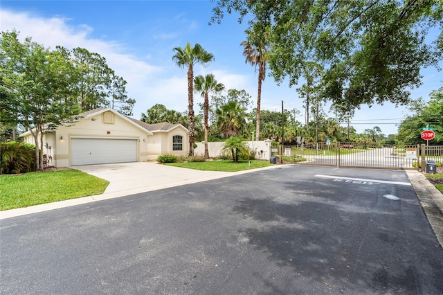 34 Raintree Cir, Palm Coast, FL 32164 - view of front of property featuring a gate, stucco siding, and a garage