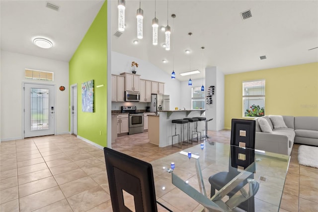 34 Raintree Cir, Palm Coast, FL 32164 - dining area with light tile patterned floors and high vaulted ceiling