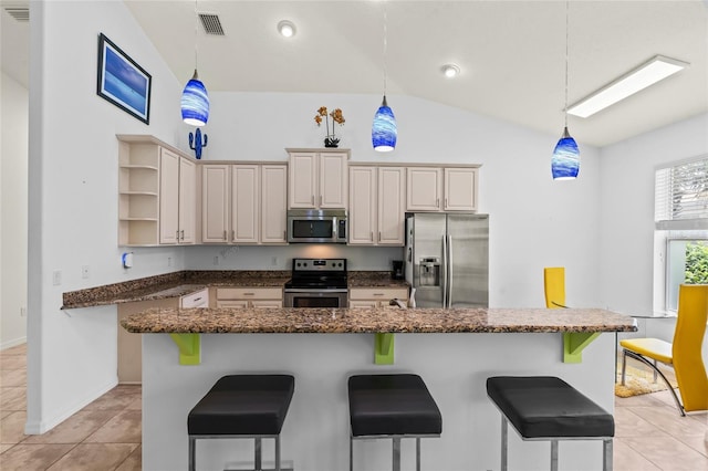 34 Raintree Cir, Palm Coast, FL 32164 - kitchen featuring stainless steel appliances, open shelves, lofted ceiling, a kitchen breakfast bar, and light tile patterned floors