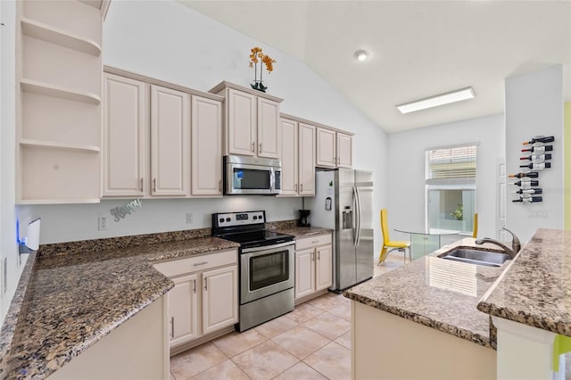 34 Raintree Cir, Palm Coast, FL 32164 - kitchen with stainless steel appliances, vaulted ceiling, open shelves, stone counters, and light tile patterned flooring