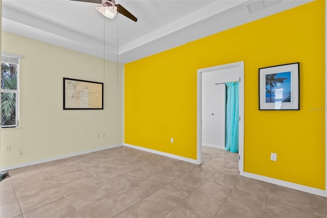 34 Raintree Cir, Palm Coast, FL 32164 - tiled empty room with a ceiling fan and a tray ceiling