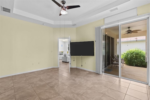 34 Raintree Cir, Palm Coast, FL 32164 - unfurnished room with a ceiling fan, a tray ceiling, and light tile patterned flooring