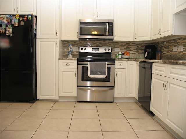 39 Benjamin Dr, Ormond Beach, FL 32176 - kitchen with black appliances, white cabinetry, light tile patterned floors, and decorative backsplash