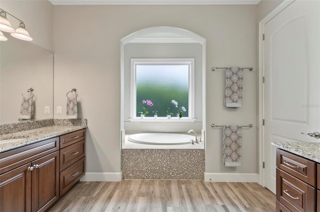 4 Midden Ln, Palm Coast, FL 32137 - bathroom with vanity, wood finished floors, and a bath