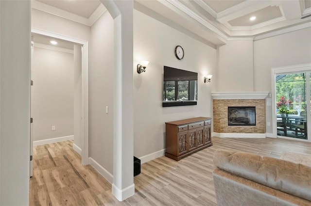 4 Midden Ln, Palm Coast, FL 32137 - living room featuring crown molding, light wood-style floors, a fireplace, arched walkways, and beam ceiling