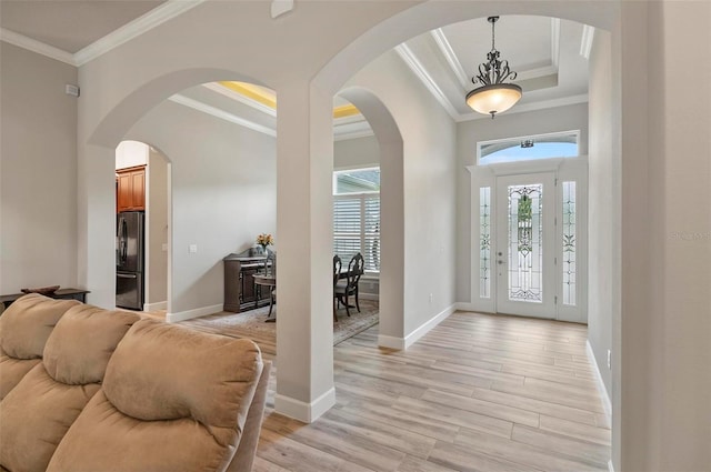 4 Midden Ln, Palm Coast, FL 32137 - foyer entrance with ornamental molding, a raised ceiling, and light wood-style flooring