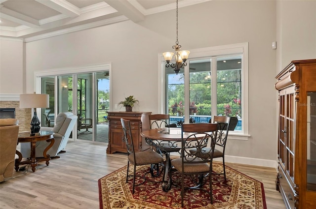 4 Midden Ln, Palm Coast, FL 32137 - dining space featuring beamed ceiling, light wood-type flooring, a chandelier, ornamental molding, and a high ceiling