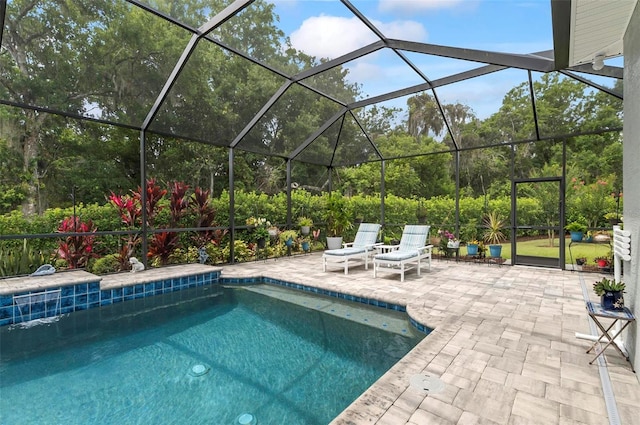 4 Midden Ln, Palm Coast, FL 32137 - swimming pool featuring a patio, glass enclosure, and view of wooded area