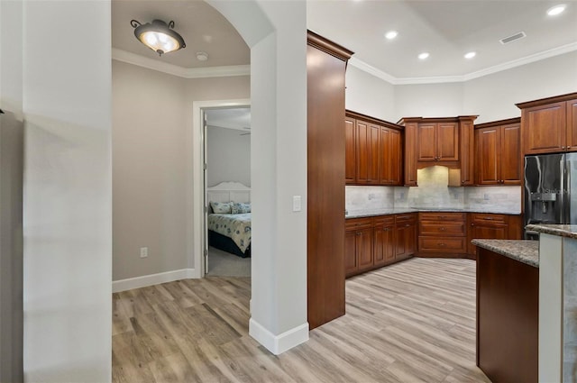 4 Midden Ln, Palm Coast, FL 32137 - kitchen featuring refrigerator with ice dispenser, light wood-type flooring, stone counters, recessed lighting, and ornamental molding