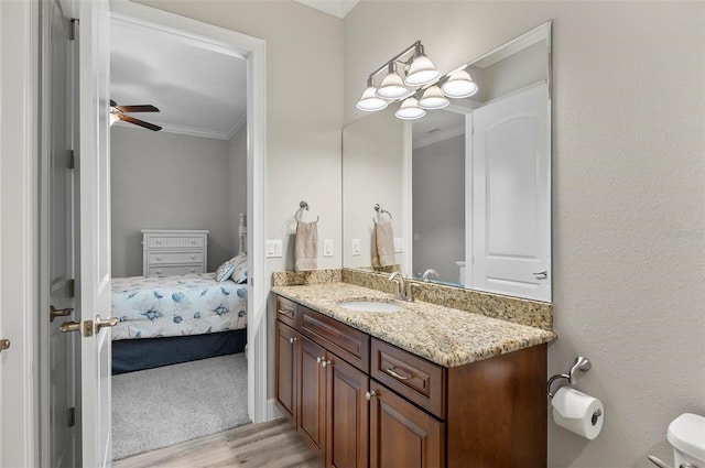4 Midden Ln, Palm Coast, FL 32137 - bathroom featuring crown molding, wood finished floors, vanity, ensuite bathroom, and a ceiling fan
