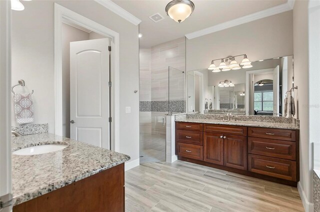 4 Midden Ln, Palm Coast, FL 32137 - bathroom featuring a shower stall, two vanities, ornamental molding, and wood finished floors