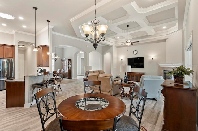 4 Midden Ln, Palm Coast, FL 32137 - dining room with a ceiling fan, a chandelier, arched walkways, light wood-type flooring, and coffered ceiling