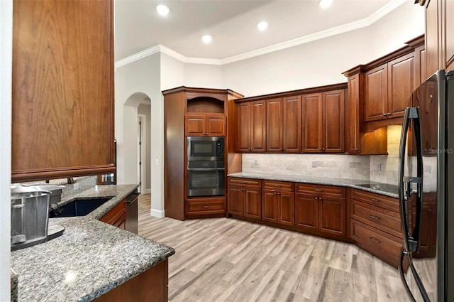 4 Midden Ln, Palm Coast, FL 32137 - kitchen featuring black appliances, ornamental molding, light wood-type flooring, tasteful backsplash, and light stone counters