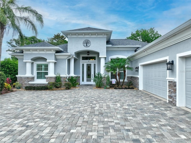 4 Midden Ln, Palm Coast, FL 32137 - view of front of house with stucco siding, stone siding, and decorative driveway