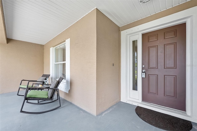 22 Post Tree Ln, Palm Coast, FL 32164 - doorway to property featuring stucco siding