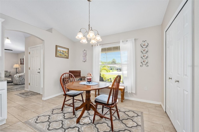 22 Post Tree Ln, Palm Coast, FL 32164 - dining space featuring arched walkways, a chandelier, lofted ceiling, and light tile patterned floors