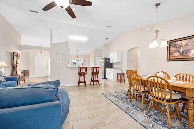 22 Post Tree Ln, Palm Coast, FL 32164 - dining area featuring ceiling fan, arched walkways, lofted ceiling, and light tile patterned floors