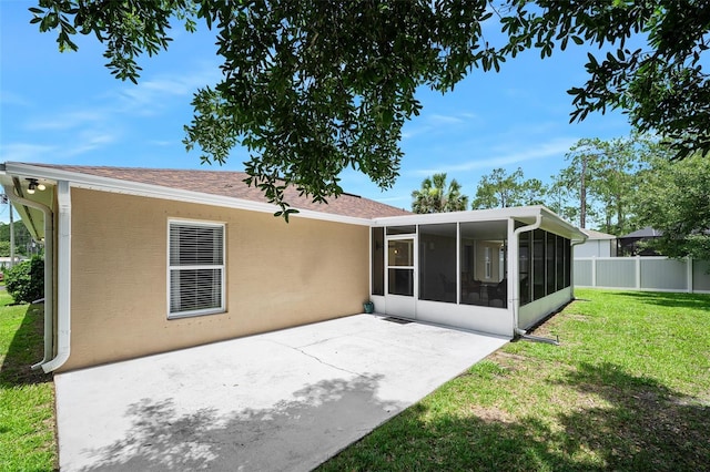 22 Post Tree Ln, Palm Coast, FL 32164 - rear view of property featuring a sunroom, a patio, stucco siding, and roof with shingles