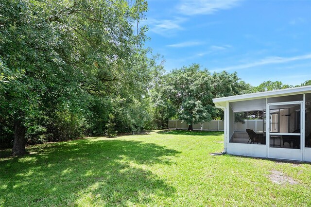 22 Post Tree Ln, Palm Coast, FL 32164 - view of yard featuring a sunroom