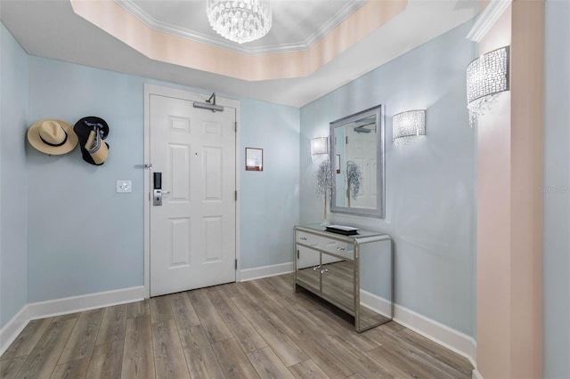 200 Ocean Crest Dr Unit 913, Palm Coast, FL 32137 - entryway with a chandelier, wood finished floors, crown molding, and a raised ceiling