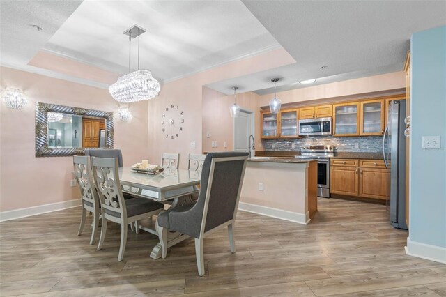 200 Ocean Crest Dr Unit 913, Palm Coast, FL 32137 - dining area with ornamental molding, light wood-style floors, and a chandelier