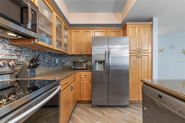 200 Ocean Crest Dr Unit 913, Palm Coast, FL 32137 - kitchen with stainless steel appliances, dark stone counters, and backsplash